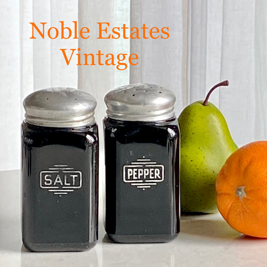 Set of black salt and pepper shakers with metal lids for sale by Noble Estates Vintage.